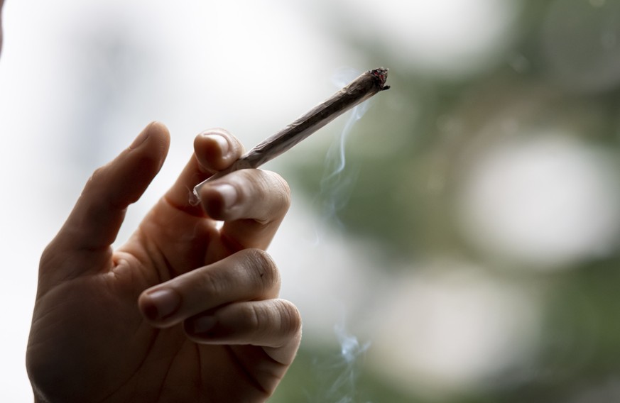 ILLUSTRATION - 27.11.2021, Berlin: ARCHIV - Eine Person raucht einen Joint. Die Ampel-Parteien wollen Cannabis f