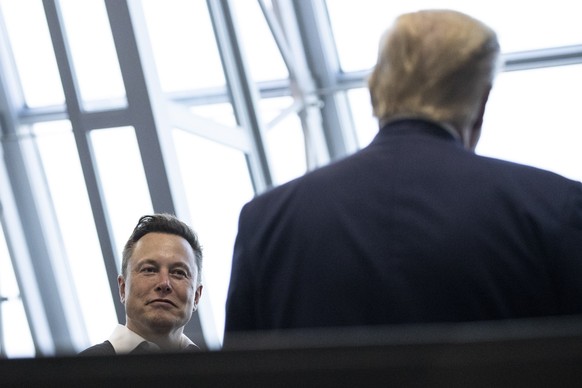 FILE - Tesla and SpaceX Chief Executive Officer Elon Musk talks with President Donald Trump speaks after viewing the SpaceX flight to the International Space Station, at Kennedy Space Center, May 30,  ...