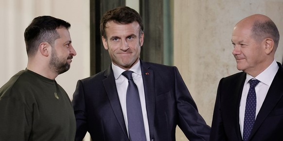 08.02.2023, Frankreich, Paris: Emmanuel Macron (M), Präsident von Frankreich, Bundeskanzler Olaf Scholz (r, SPD) und Wolodymyr Selenskyj, Präsident der Ukraine, stehen vor ihrem Arbeitsessen im Elysee ...