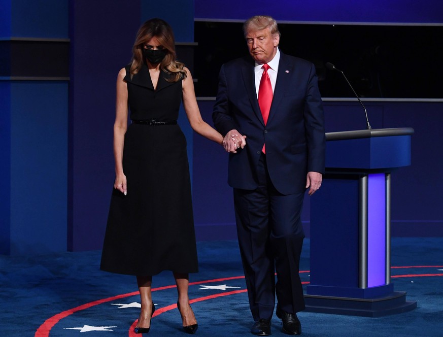 Republican presidential candidate President Donald Trump and first lady Melania Trump stand onstage after the final presidential debate with Democratic presidential candidate former Vice President Joe ...