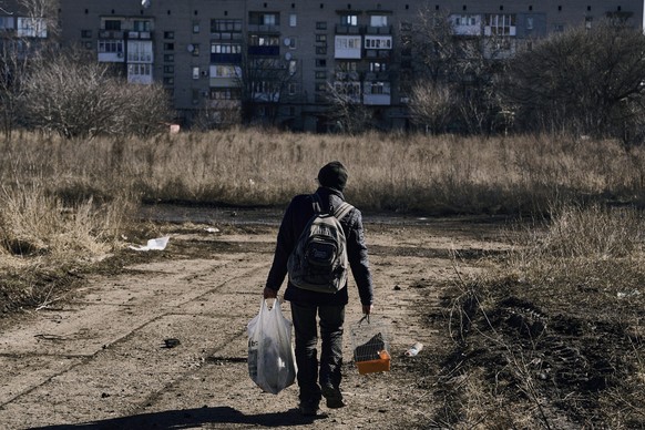 A local resident leaves his hometown in Chasiv Yar, Donetsk region, Ukraine, Monday, March 6, 2023. (AP Photo/Libkos)
