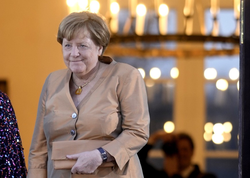 Former German Chancellor Angela Merkel arrives at the Bellevue Palace to attend the State Banquet in Berlin, Wednesday, March 29, 2023. King Charles III arrived Wednesday for a three-day official visi ...
