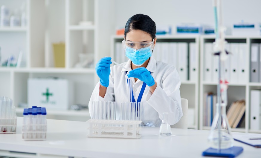 Shot of a young scientist conducting an experiment in a laboratory