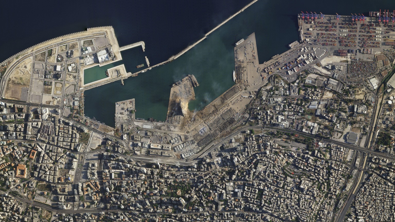 This satellite image taken on Wednesday Aug. 5, 2020 shows the port of Beirut and the surrounding area in Lebanon following a massive explosion on Tuesday. Residents of Beirut confronted a scene of ut ...