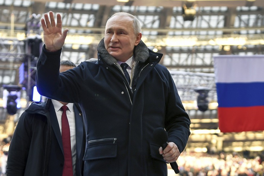 Russian President Vladimir Putin waves as he arrives to attend a concert a day before the Defender of the Fatherland Day, a holiday honoring Russia&#039;s armed forces, at the Luzhniki Stadium in Mosc ...