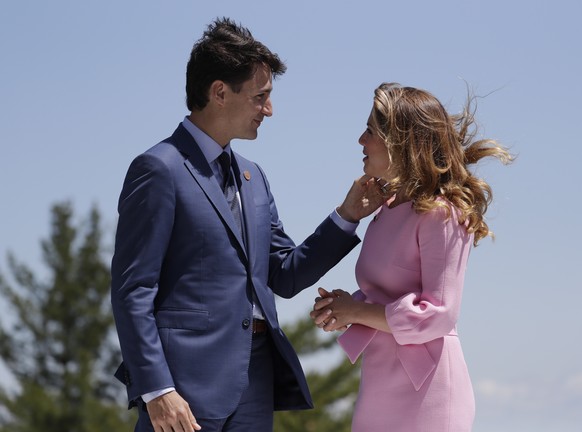 Canadian Prime Minister Justin Trudeau and his wife Sophie Gregoire Trudeau talk prior to the beginning of a welcoming ceremony during the G7 Summit, Friday, June 8, 2018, in Charlevoix, Canada. (AP P ...