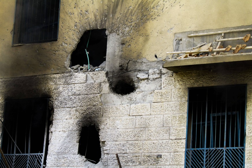 May 11, 2021: Gaza, Palestine. 12 May 2021. Palestinian Civil Defence extinguish a fire at the Sheikh Zaid residential tower in Beit Lahia, in the northern Gaza Strip, following a bombardment by Israe ...