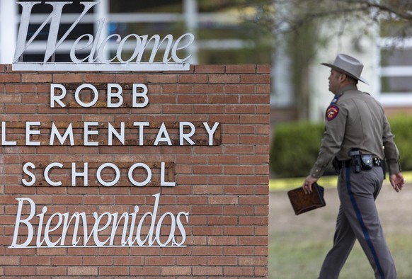 24.05.2022, USA, Uvalde: Ein Polizist geht nach einem Amoklauf an der Grundschule Robb Elementary School an einem Schriftzug der Schule vorbei. Bei einem Amoklauf an einer Grundschule im US-Bundesstaa ...