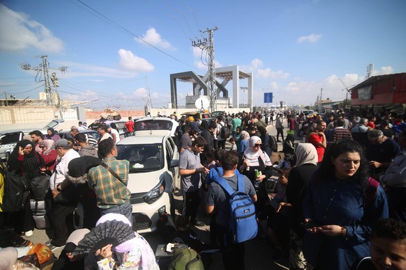 231016 -- GAZA, Oct. 16, 2023 -- People wait for the opening of the Rafah border crossing in the southern Gaza Strip city of Rafah, on Oct. 16, 2023. The Gaza-ruling Palestinian Islamic Resistance Mov ...