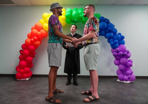Syndication: USA TODAY Anthony Thomas, and his partner Nicolas Anderson share a moment together while getting married by Judge Nicholas Chu on Monday afternoon. At least twenty-four couples or more ma ...
