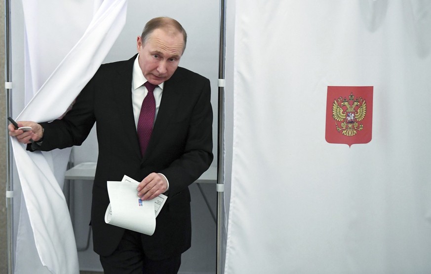FILE - Russian President and Presidential candidate Vladimir Putin exits a polling booth as he prepares to cast his ballot during Russia&#039;s presidential election in Moscow, Russia, Sunday, March 1 ...