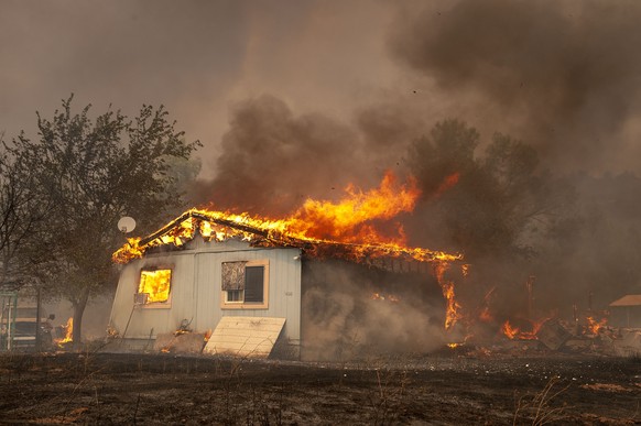 04.08.2018, USA, Lucerne: Ein Spring Valley Haus wird von Flammen verzehrt, als sich das Ranch Fire in Lake County California weiter nach Westen ausdehnte. Foto: Mark Mckenna/ZUMA Wire/dpa +++ dpa-Bil ...