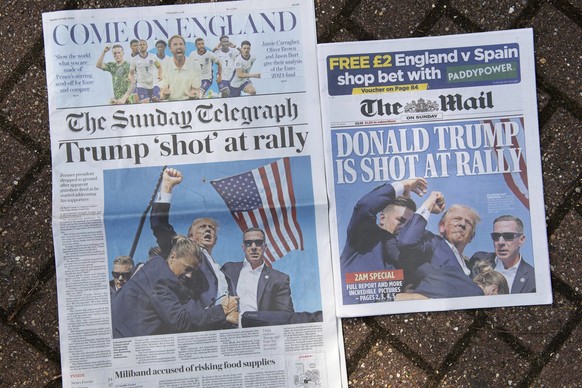 Two front pages of British national newspapers, late editions for London, Sunday, July 14, 2024, showing the reaction to events at former President Trump campaign rally in Butler, Pennsylvania. Donald ...