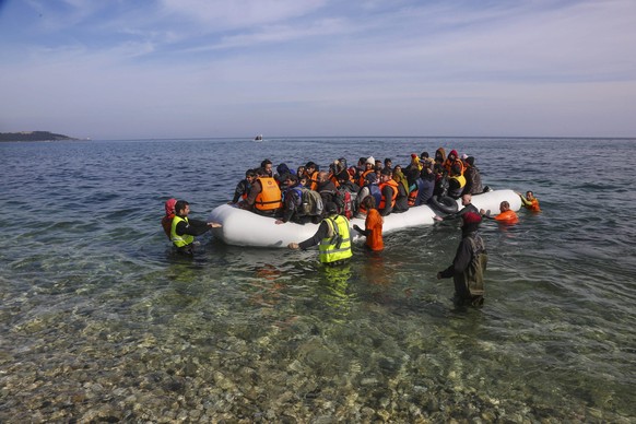 Refugees and migrants arriving at Lesvos island, Greece on March 12,2016. Refugees arriving at Lesvos in a rubber dinghy boat after they flee from their home country. They travel from Turkey to Greece ...