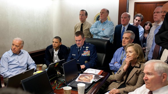 WASHINGTON, DC - MAY 1: (EDITORS NOTE: Please be advised that a classified document visible in this photo was obscured by The White House) In this handout image provided by The White House, President ...