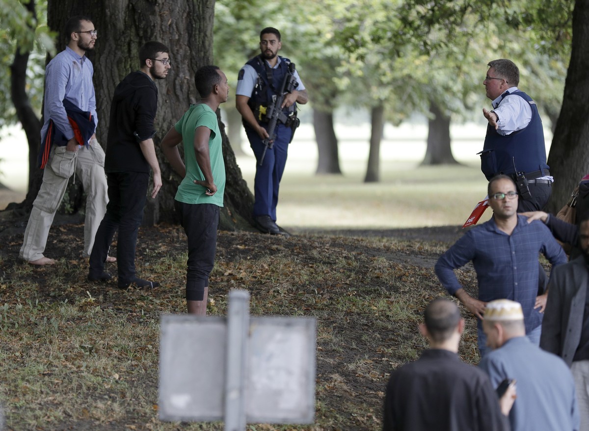 Police attempt to move people away from outside a mosque in central Christchurch, New Zealand, Friday, March 15, 2019. Many people were killed in a mass shooting at a mosque in the New Zealand city of ...