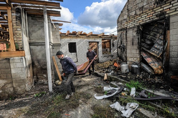 September 24, 2022, Moshchun, Ukraine: People clear the rubble of a house destroyed as a result of the shelling in the village of Moshchun near Kyiv. Russia invaded Ukraine on 24 February 2022, trigge ...