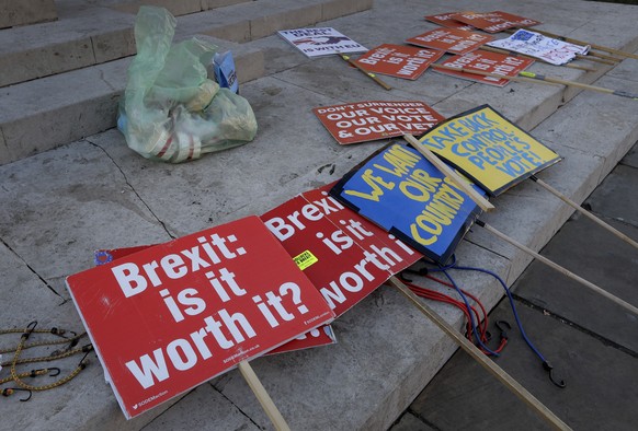 Brexit banners lie on the ground near parliament in London, Thursday, Jan. 17, 2019. British Prime Minister Theresa May is reaching out to opposition parties and other lawmakers Thursday in a battle t ...