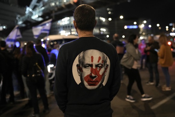 FILE - A protester wears a shirt depicting Israeli Prime Minister Benjamin Netanyahu attempt during a demonstration to demand the release of the hostages taken by Hamas militants into the Gaza Strip d ...
