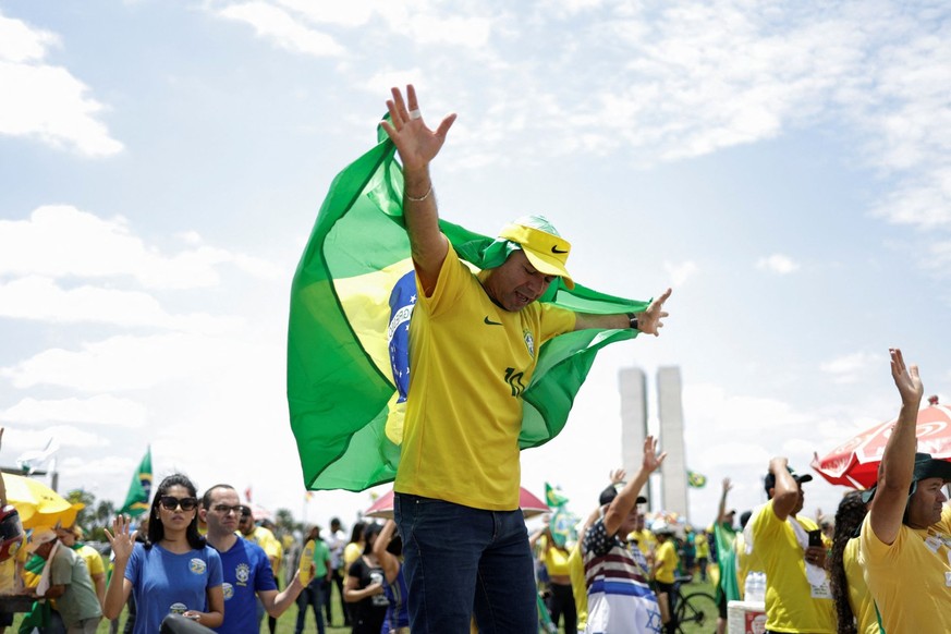 A supporter of Brazil&#039;s President Jair Bolsonaro prays while taking part in family event organised by evangelical pastors, in Brasilia, Brazil October 1, 2022. REUTERS/Ueslei Marcelino