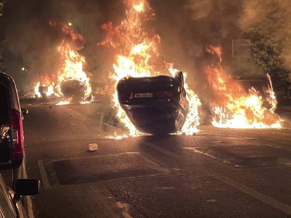 France Riots 8469707 29.06.2023 Burning vehicles are seen during clashes between protesters and police, after the death of Nahel, a 17-year-old teenager killed by a French police officer during a traf ...