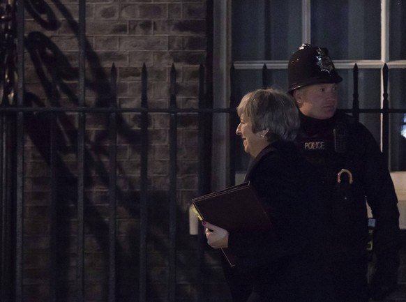(181210) -- LONDON, Dec. 10, 2018 -- British Prime Minister Theresa May (Front) arrives at 10 Downing Street after making a statement in the House of Commons, in London, Britain, Dec. 10, 2018. Theres ...