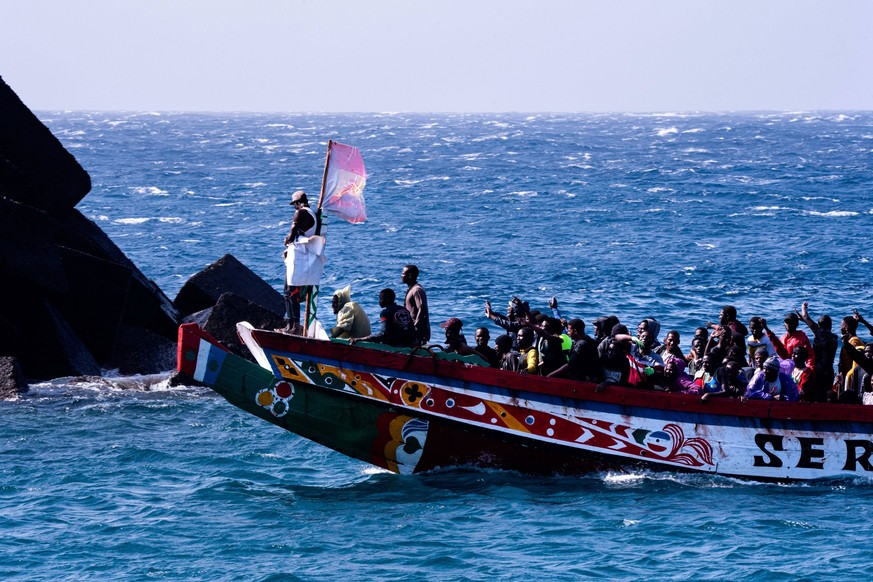 August 22, 2024, El Hierro, Canary Islands, Spain: A group of migrants celebrate surviving the sea crossing from Africa to Europe minutes before entering the Canary Island port of La Restinga. 358 peo ...