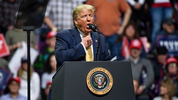 COLORADO SPRINGS, CO - FEBRUARY 20: President Donald Trump mocks choking while describing Democratic Presidential candidate Mike Bloomberg's debate performance during a Keep America Great rally on Feb ...