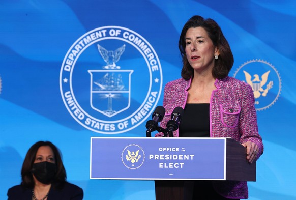 WILMINGTON, DELAWARE - JANUARY 08: U.S. Vice President-elect Kamala Harris (L) looks on as Rhode Island Gov. Gina Raimondo (R) delivers remarks after U.S. President-elect Joe Biden announced her as hi ...