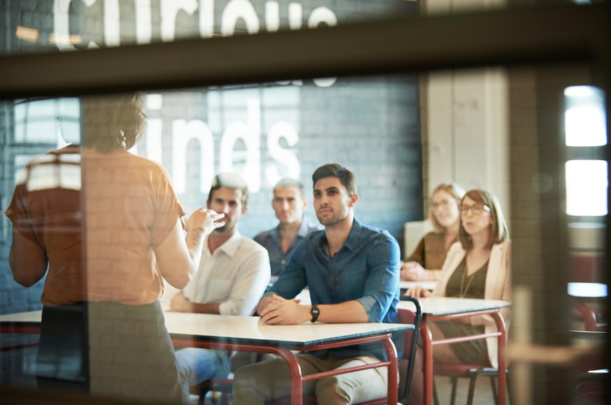 Shot of a group of businesspeople sitting in the boardroom during a presentation