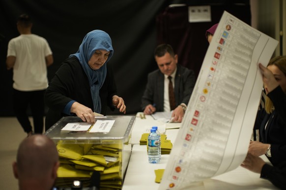 14.05.2023, Türkei, Istanbul: Eine Frau wählt in einem Wahllokal. In der Türkei haben am Sonntag die Parlaments- und Präsidentenwahlen begonnen. Es wird erwartet, dass diese Wahlen hart umkämpft sein  ...