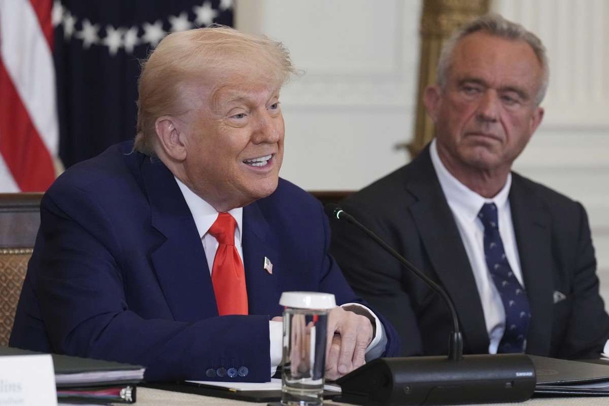 President Donald Trump, left, speaks as Health and Human Services Secretary Robert F. Kennedy Jr. listens during a Make America Healthy Again (MAHA) Commission Event in the East Room of the White Hous ...