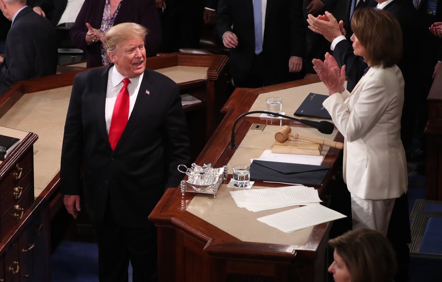 U.S. President Donald Trump says something to Speaker of the House Nancy Pelosi (D-CA) after concluding his second State of the Union address to a joint session of the U.S. Congress in the House Chamb ...