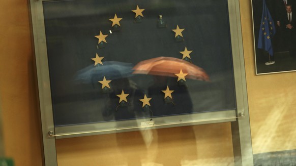 Passers-by are reflected in an artwork based on the European Union flag, with one star missing, in the European Commissions headquarters in Brussels, Monday, Nov. 12, 2018. Britain's European Union pa ...