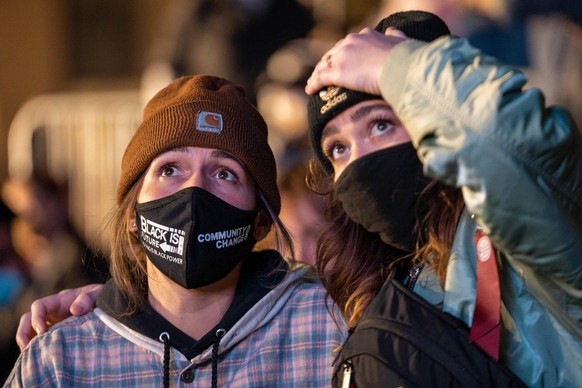 Shannon Epstein, 23 left, and Bekah Carlson, 24, right, react while watching CNN election results at McPherson Square near the White House on election night in Washington, DC on Tuesday, November 3, 2 ...