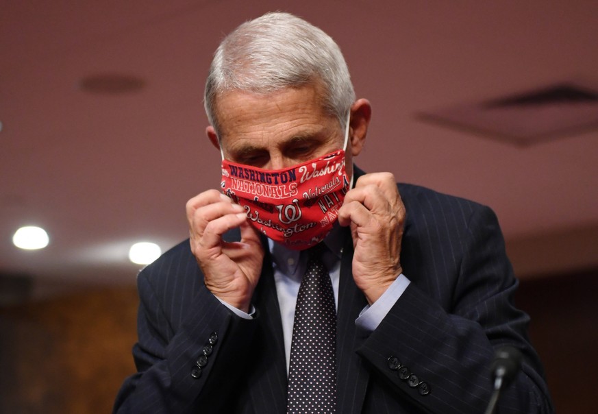 Dr. Anthony Fauci, director of the National Institute for Allergy and Infectious Diseases, adjusts his face mask as he prepares to testify before the Senate Health, Education, Labor and Pensions HELP  ...