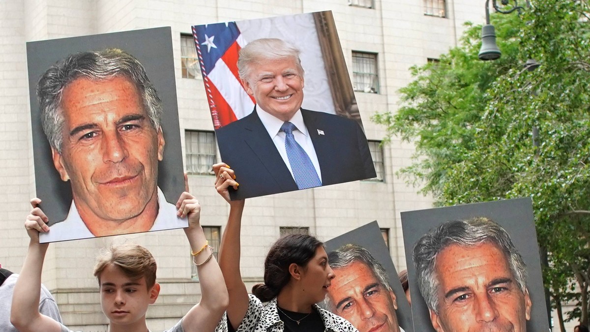 People hold up photos of Jeffrey Epstein and President Donald Trump while Billionaire Jeffrey Epstein awaits a bail hearing at Manhattan Federal Court after being arrested Saturday on sex-trafficking  ...