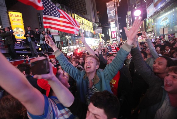 NEW YORK, NY - MAY 02: People celebrate in Times Square after the death of accused 9-11 mastermind Osama bin Laden was announced by U.S. President Barack Obama May 2, 2011 in New York City. A special ...