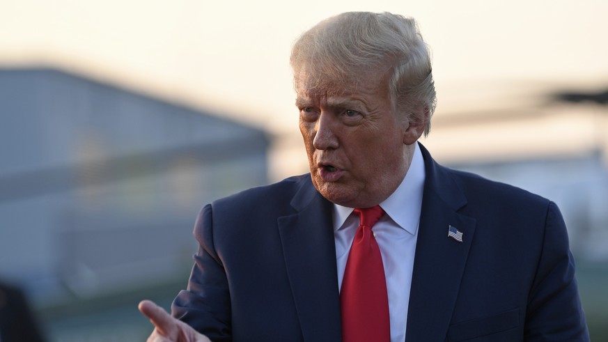 President Donald Trump talks with reporters before departing from Morristown Municipal Airport in Morristown, N.J., Sunday, Aug. 9, 2020. Trump was returning to Washington after spending the weekend a ...