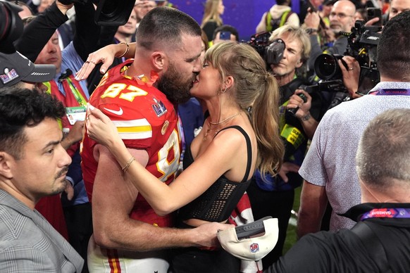 Taylor Swift kisses Kansas City Chiefs tight end Travis Kelce after the NFL Super Bowl 58 football game against the San Francisco 49ers, Sunday, Feb. 11, 2024, in Las Vegas. The Chiefs won 25-22. (AP  ...
