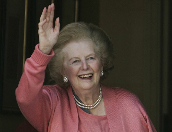 FILE - In this Monday June 29, 2009 file photo, former British Prime Minister Margaret Thatcher waves to members of the media following her return home from hospital suffering from a broken arm, in ce ...