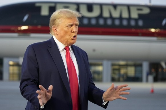 FILE - Former President Donald Trump speaks with reporters before departure from Hartsfield-Jackson Atlanta International Airport, Thursday, Aug. 24, 2023, in Atlanta. Trump has called for the impeach ...