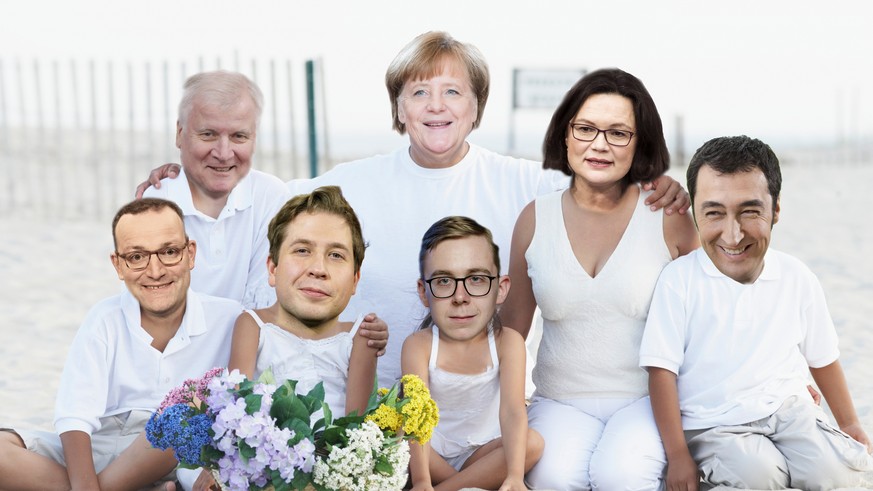 Portrait of a mid adult couple sitting on the beach with their five children