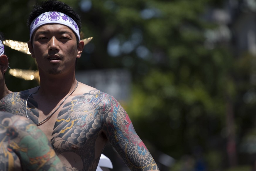 May 17, 2014 - Tokyo, Japan - A member of the Yakuza shows off his tattoos during the Sanja Matsuri on May 17 2014 in Tokyo s Asakusa district Japan. Two million people are expected over the three day ...