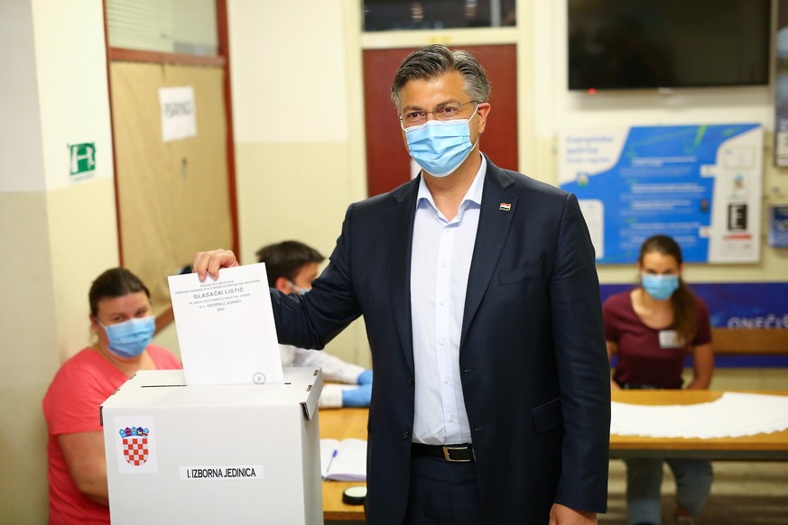 Croatian Prime Minister and the leader of Croatian Democratic Union (HDZ) Andrej Plenkovic casts his ballot during parliamentary election, amid the spread of the coronavirus disease (COVID-19), in Zag ...