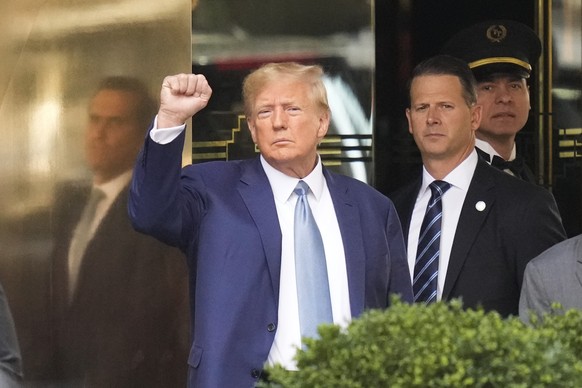 FILE - Former President Donald Trump, left, gestures as he leaves Trump Tower in New York, Thursday, April 13, 2023. The judge in Donald Trump&#039;s criminal case is holding a hybrid hearing Tuesday  ...