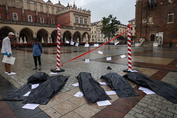Plastic bags symbolizing the bodies of refugees who died at the Belarusian-Polish border and a barbed wired fence with border posts were placed at the Main Square during &#039;Enough of Death on our B ...