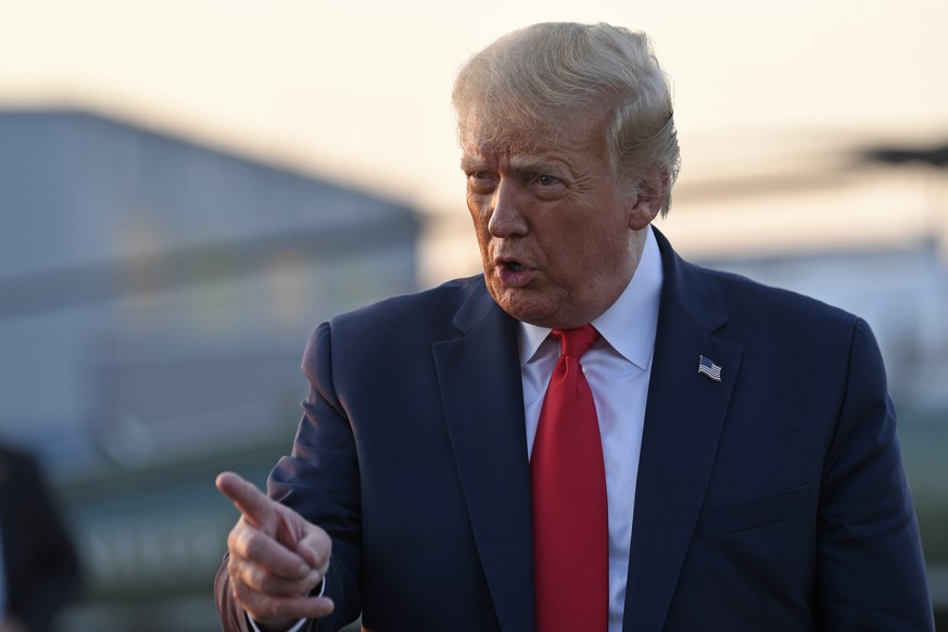 President Donald Trump talks with reporters before departing from Morristown Municipal Airport in Morristown, N.J., Sunday, Aug. 9, 2020. Trump was returning to Washington after spending the weekend a ...