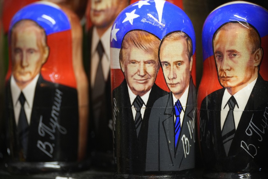 Traditional Russian wooden dolls, called Matryoshka, depicting Republican presidential nominee an former US President Donald Trump, center left, and Russian President Vladimir Putin are displayed for  ...