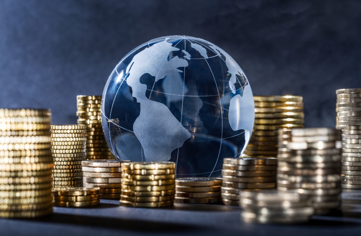 Globe and stack with coins. Money makes the world go round